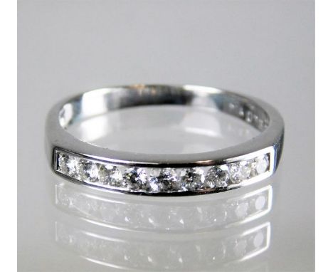 A white metal, tests at 18ct gold, half eternity ring set with 0.33ct of diamonds 2.6g size N