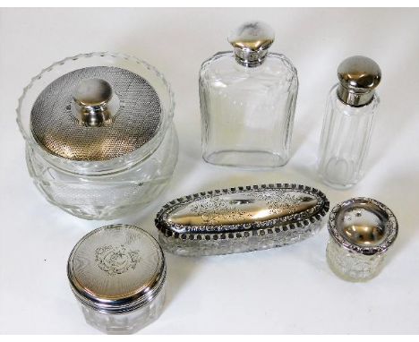 A silver topped flask twinned with five other silver topped items