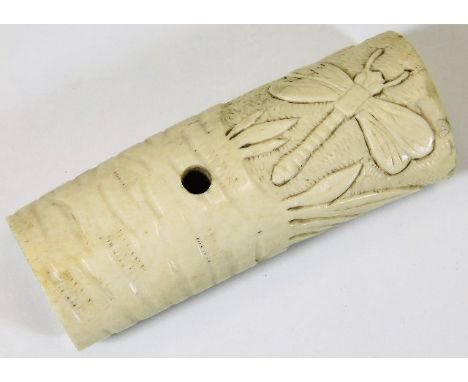 An Oriental carved bone handle, possibly from a ceremonial dagger depicting a dragonfly among reeds 3.875in long