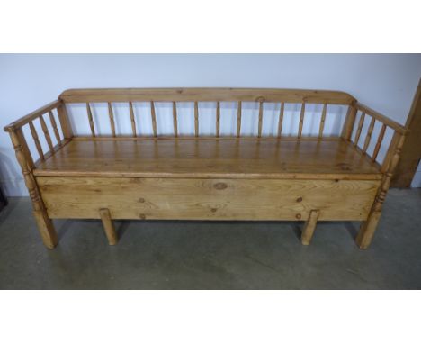 A 19th century continental pine hall bench with lift up top and pull out day bed section - Height 80cm x Width 190cm x Depth 