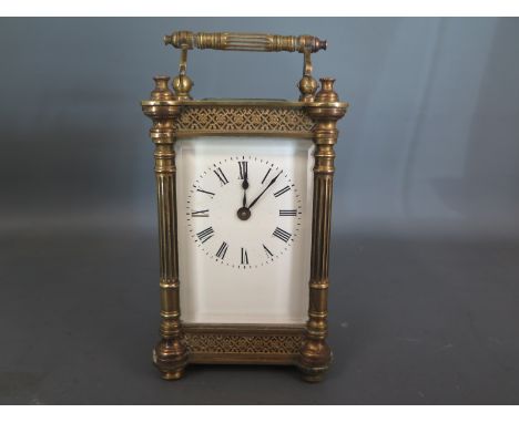 A brass cased, five bevelled glass panelled carriage clock, Roman numerals to white enamel dial - in working condition