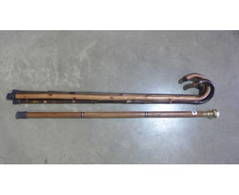 Four walking sticks one with compass and a spirit vial in brass handle