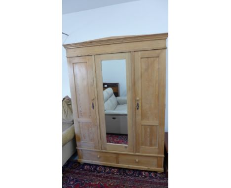 A Victorian Continental knockdown triple wardrobe with a central mirrored door and two base drawers - Height 208cm x 149cm x 