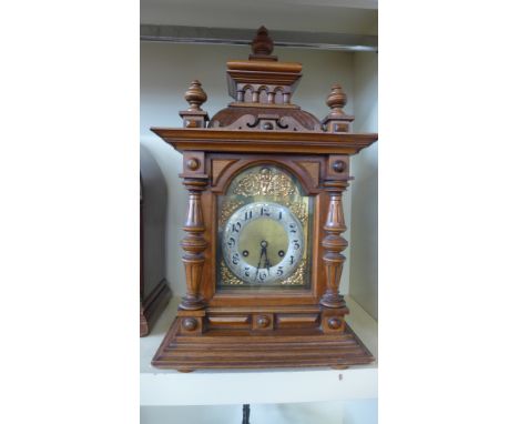 A walnut cased Junghams mantle clock striking on two gongs - Height 55cm