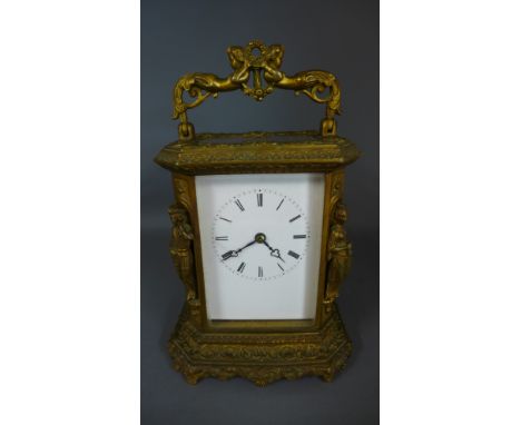 A good quality French cast gilt brass carriage clock with 8 day movement by Japy Freres striking on a bell with cherub handle