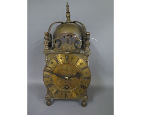 A brass lantern clock by Elliot of London, Roman numerals to chapter ring with engraved dial - Height 25cm