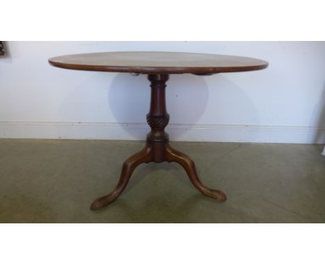 A Georgian mahogany tripod table with a one piece tilt top on a turned wrythen base - Height 70cm x Diameter 94cm 