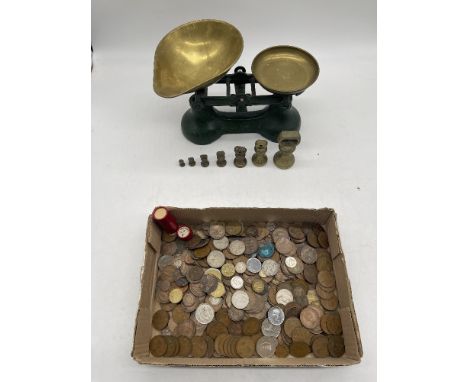 Vintage Green Kitchen Scales with 7 Brass Weights, along with a collection of coins. 