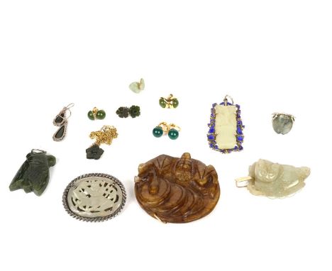 A selection of serpentine jewellery, (jade simulant), including a circular pendant with bat decoration; a vase of flowers in 