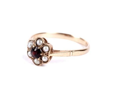 An early 20th Century garnet and seed pearl flower cluster ring, in yellow gold, hallmarks worn, size O, 1.8g gross.
