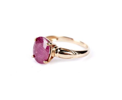 A ruby single stone dress ring, the four claw mounted faceted oval ruby approximately 9.5 x 7.4mm, in 9ct yellow gold, size N