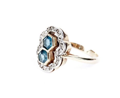 A blue stone and diamond cluster ring, the two blue stones, probably spinel, surrounded by diamonds in a figure-of-eight moun