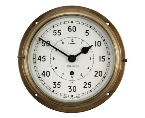 * Clock. A WWII period Royal Navy brass bulkhead clock, the circular white enamel dial with Arabic numerals, numbered 0552/46