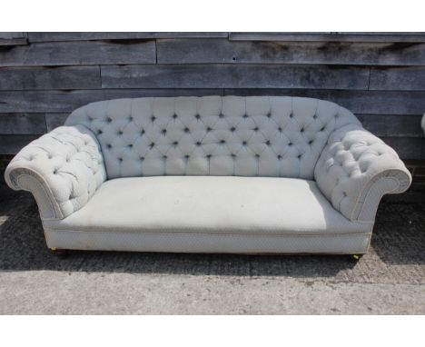 A chesterfield settee, button upholstered in a light blue fabric, 83" wide x 33" deep x 32" high 