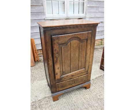 An 18th century oak side cupboard enclosed arch top door over one drawer, on bracket feet, 31" wide x 11" deep x 38 1/2" high