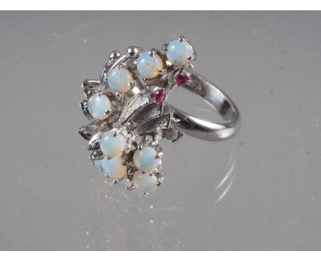 A white metal, moonstone and garnet cocktail ring, size N, 7.1g 
