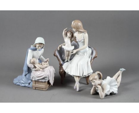 A Lladro figure of a woman and child on a sofa, 10” wide, and two Nao figuresCondition report: Two petals on woman's head ban