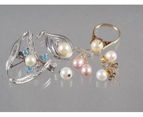 A white metal brooch set faux pearl and aqua coloured stones, a white metal and pearl pendant, a 9ct gold ring set single pea