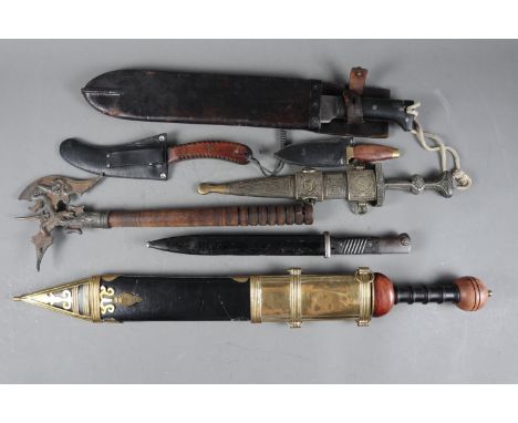 A WWII Collins &amp; Co USA machete, a WWII bayonet and scabbard, a gladiator style sword, three other daggers and a reproduc