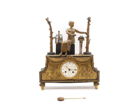 An ormolu mantel clock c. 1860, French, with a seated lady, next to a birdcage, above an enamel dial, with Roman numerals, an