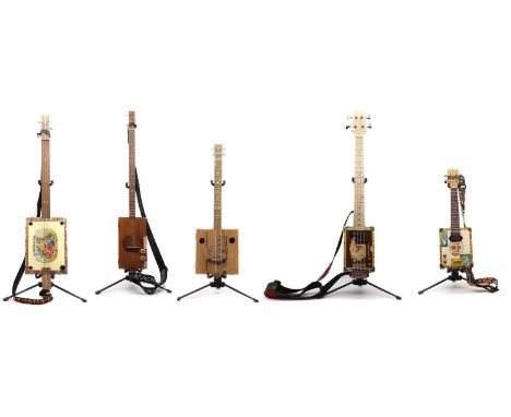 Five 'Cigar Box' ukuleles four with straps, together with a Laney RB1 Richter Bass guitar ampCondition ReportThe 'Punch' ukul