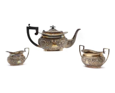 A three piece silver tea service by George Nathan &amp; Ridley Hayes, Chester 1900, comprising a teapot, 32cm wide, twin-hand