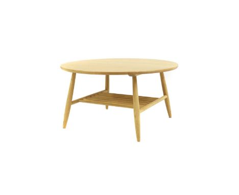 An Ercol oak 'Shalstone' coffee table, of recent manufacture, the round top raised on turned supports united by a magazine ra