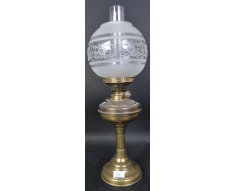 A Victorian 19th Century brass oil lamp. Having a brass fuel chamber supported on central column with a tapering circular bas