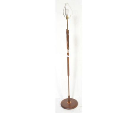 A vintage retro mid-20th century circa. 1970's teak wood standard floor standing lamp with floral bell shade.&nbsp; The base 