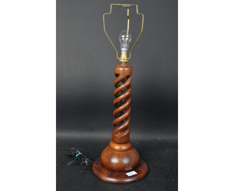 A vintage 20th Century mahogany open pierced barley twist lamp base. With brass shade fitting to top, twist column on circula
