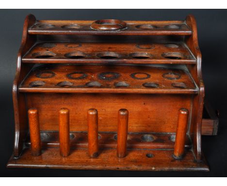 A vintage 20th Century mahogany scientific beaker test tube holder rack. Rectangular form, step front with sectional hole int