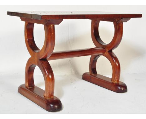 A vintage 20th Century mahogany hardwood coffee table. Of rectangular form with spanner look semi circular cross banded base 