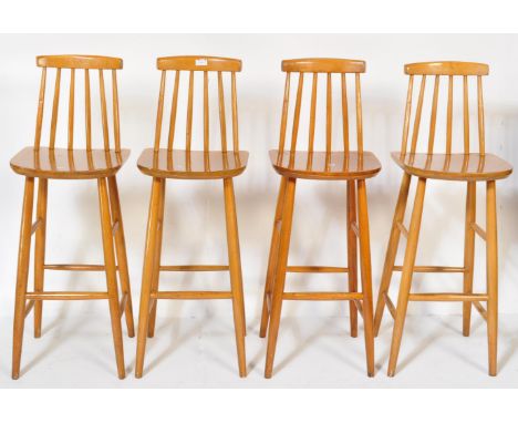 A set of four retro vintage mid 20th Century Ercol style bar stools light wood chamfered dowel legs, low back dowel back rest