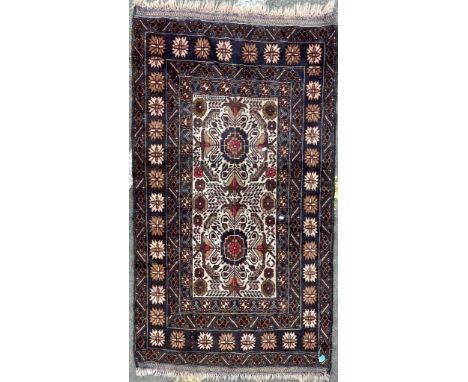 A vintage mid 20th Century Caucasic Kazak floor carpet rug. Having central panel with stylized floral patterns encapsulated w