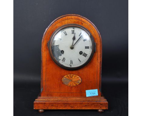 An early 20th century Edwardian circa. 1900 mahogany inlaid 8 day mantel clock of domed form having silvered face with Roman 