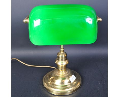 A vintage 20th century library bankers lamp The lamp having a green shade with brass stand raise on circular stepped foot. Me
