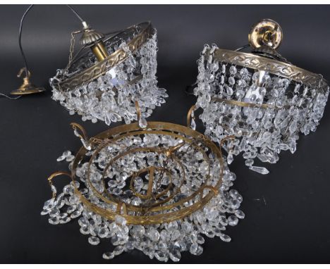 Three mid century, circa 1950's neo-classical large 4 section drop Empire chandeliers. Each chandelier having multiple facet 