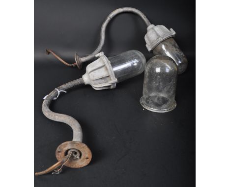 A pair of retro vintage 20th century metal industrial yard wall lights / lamps. Each light having a scrolled neck with a bulk