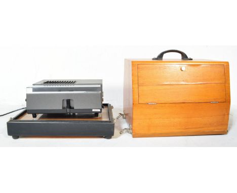 A mid 20th Century oak wood projector case being hand made with sectional top enclosing a Hanimex auto projector. Measures ap