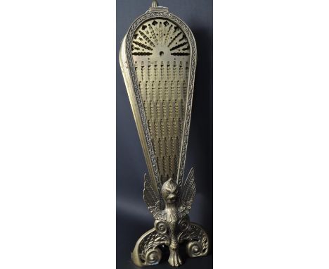 An early 20th century brass extending peacock fireguard having moulded griffin figure to centre with pierced panels. Measures