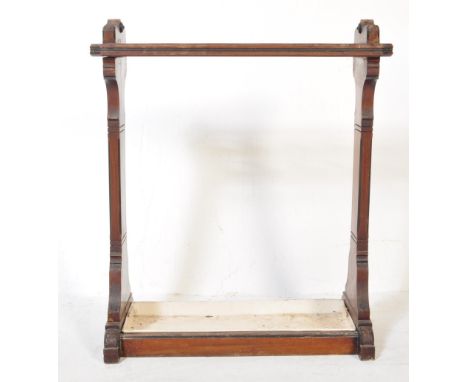 A Victorian 19th century mahogany Aesthetic movement stick stand - umbrella stand. The base with inset metal drip tray having