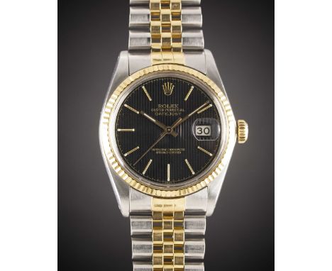 A GENTLEMAN'S STEEL & GOLD ROLEX OYSTER PERPETUAL DATEJUST BRACELET WATCHCIRCA 1983, REF. 16013 WITH BLACK "TAPESTRY" DIALMov