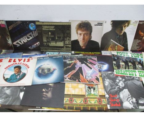 A collection of 12" vinyl records including David Bowie, Jefferson Starship, Elton John, Rod Stewart, Madonna, Michael Jackso