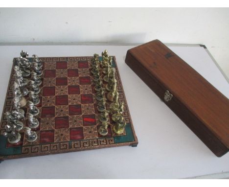 A cast metal chess set and board in the form of Cavaliers, both kings A/F