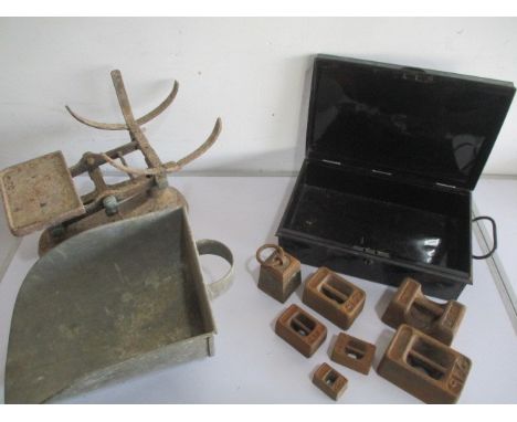 A set of shop scales along with a number of weights