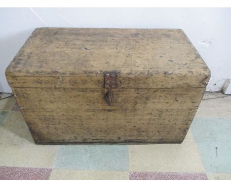 A small antique pine trunk with brass handles