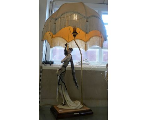 Capodimonti (Giuseppe Armani, Florence); circa 1987, an Art Deco Style table lamp of a flapper lady with a peacock