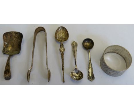 A George III silver bright cut caddy spoon Exeter 1790, a napkin ring and three other silver items