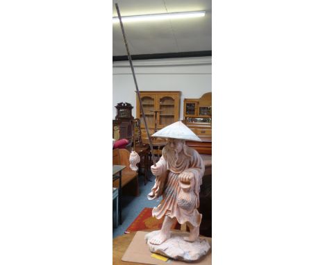 A late 20th century Chinese pink variegated marble statue of a fisherman, height 71cm