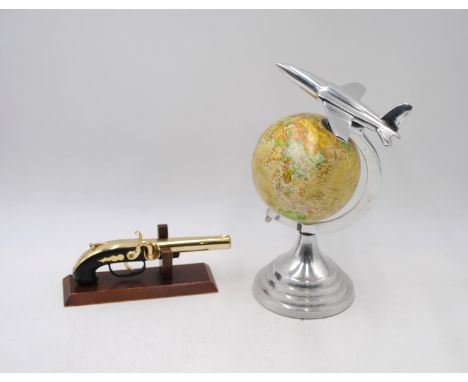 An Art Deco style globe, with chrome aeroplane finial and mounts, along with an ornamental brass flintlock on stand 